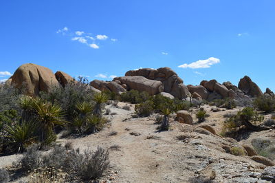 Rock formations on landscape against sky