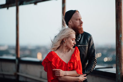 Young couple standing on bridge