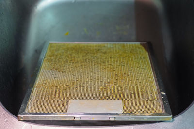 High angle view of yellow container on table