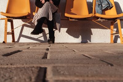 Low section of man sitting on street