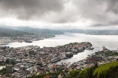 High angle view of townscape by sea against sky