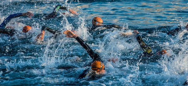 Side view of people swimming