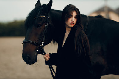 Young woman with horse