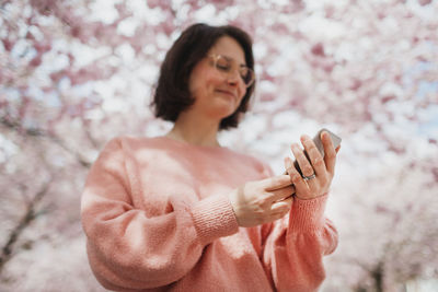 Womans hands holding cell phone