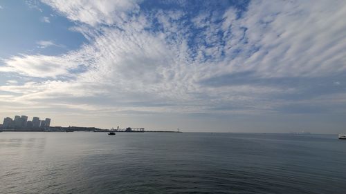 Scenic view of sea against sky in city