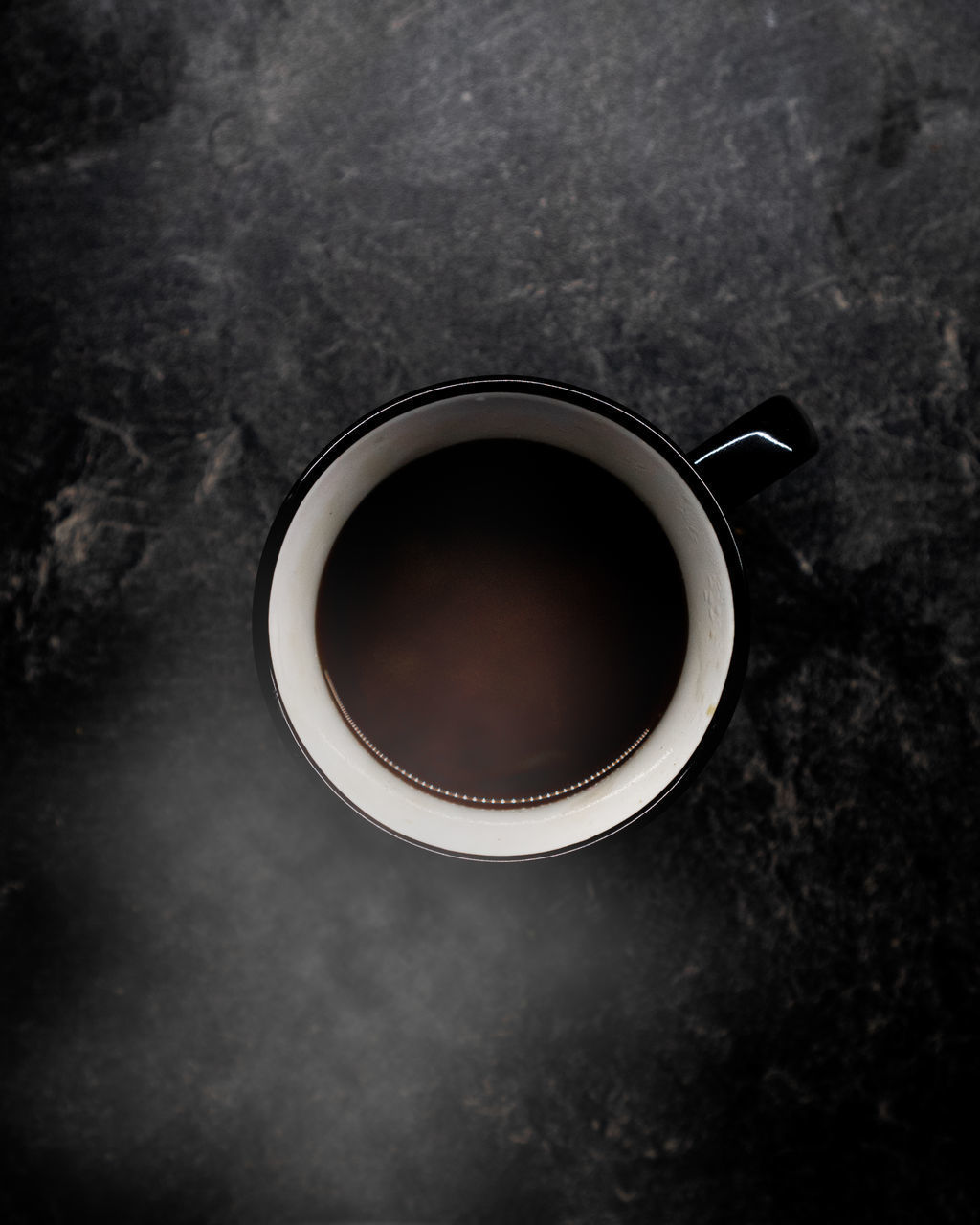 HIGH ANGLE VIEW OF COFFEE CUP WITH BLACK TEA