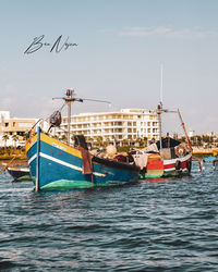 People on sea against sky