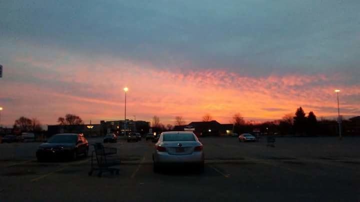 CARS ON CITY STREET AGAINST SKY AT SUNSET