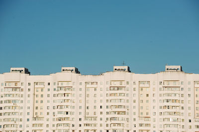 Low angle view of buildings against clear blue sky