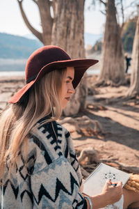 Midsection of woman wearing hat