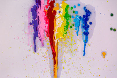 High angle view of multi colored pencils on white background