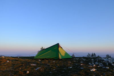 Tent on field against clear sky