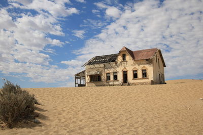 House on beach against sky