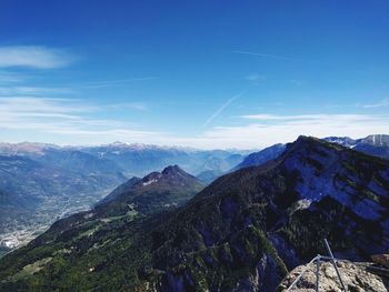 Scenic view of mountains against blue sky