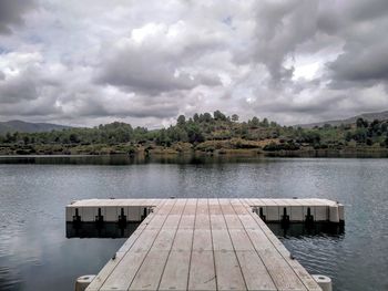 Pier over lake against sky