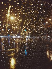 Close-up of wet window at night