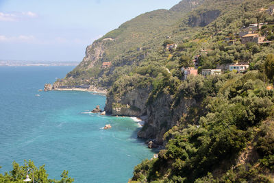 Scenic view of sea and buildings against sky