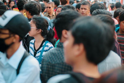 Rear view of people looking at crowd