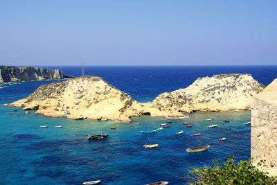 Scenic view of sea against clear blue sky