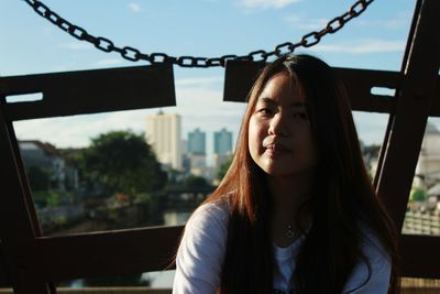 Close-up of young woman against sky