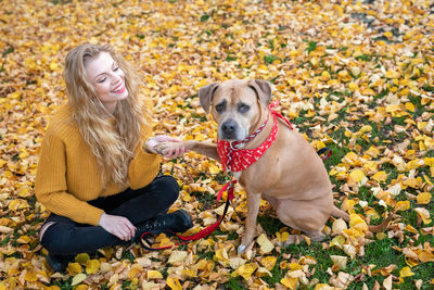 Portrait of woman with dog during autumn