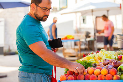 Midsection of man standing at market stall