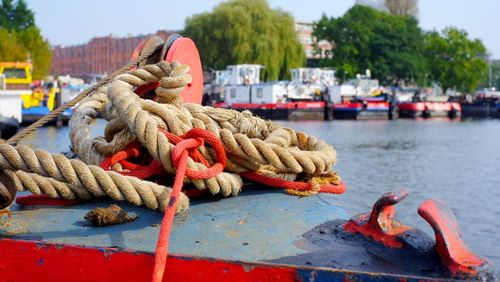 Close-up of rope tied on boat moored at harbor
