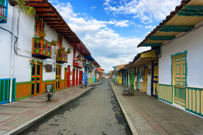 Colorful houses in street of salento against cloudy sky