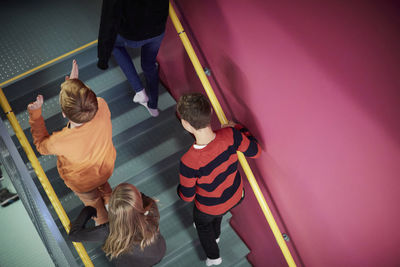 High angle view of middle school boys and girls walking upstairs