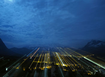 High angle view of city lit up at night