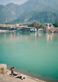 High angle view of man on bridge over sea