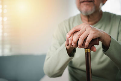 Midsection of doctor examining patient at home