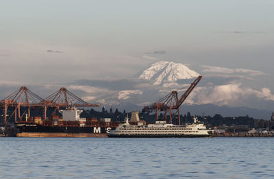 Commercial dock by sea against sky