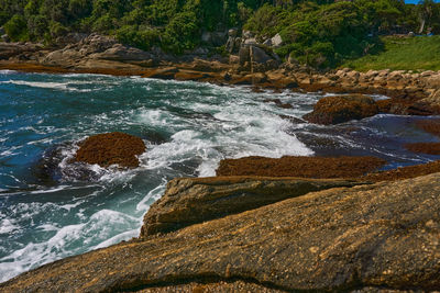 Scenic view of sea against rocks