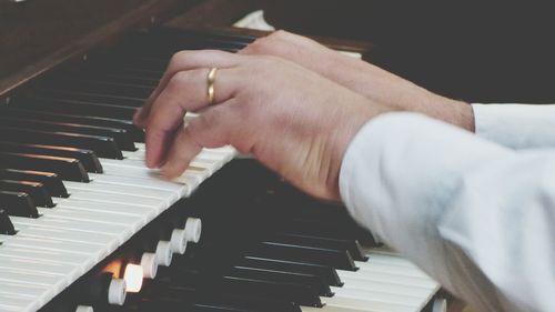 Cropped image hands playing piano