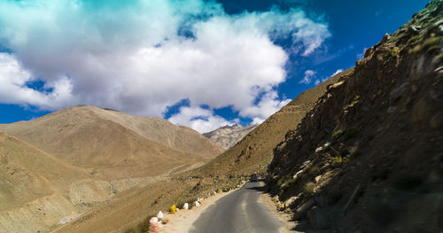 Panoramic view of road amidst mountains against sky