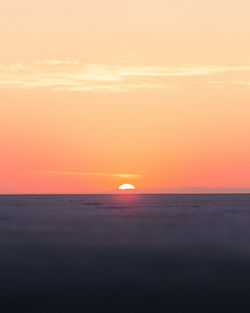 Scenic view of sea against romantic sky at sunset