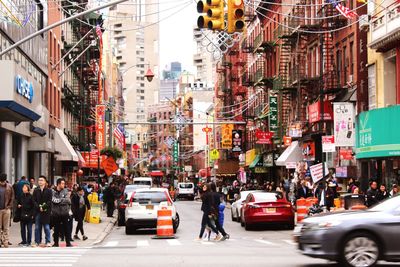 Road amidst buildings in city