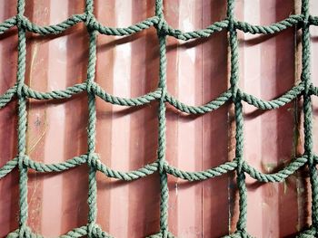 Full frame shot of ropes hanging from metal wall