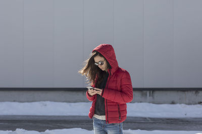 Full length of woman standing in snow