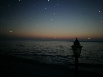 Scenic view of sea against clear sky at night