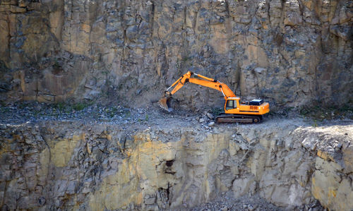 Damaged working on rock at construction site