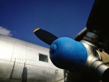 Low angle view of airplane flying against sky