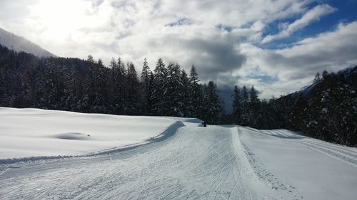 Road passing through snow covered landscape