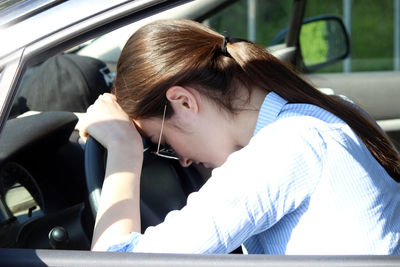 Portrait of woman sitting in car