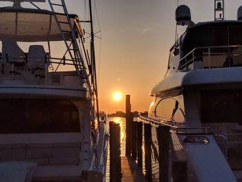 Boats in marina at sunset