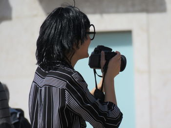 Close-up of young man photographing in city
