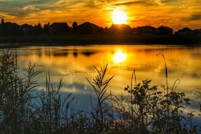 Scenic view of lake at sunset