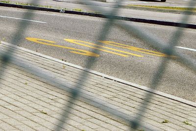 High angle view of yellow shadow on road