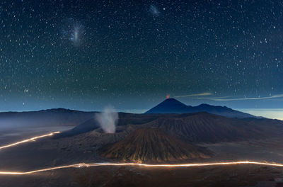 Volcanic mountains against sky at night